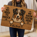 Australian Shepherd doormat held indoors, showing the detailed dog artwork and paw print accents