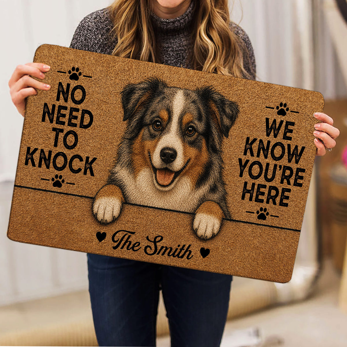 Australian Shepherd doormat held indoors, showing the detailed dog artwork and paw print accents