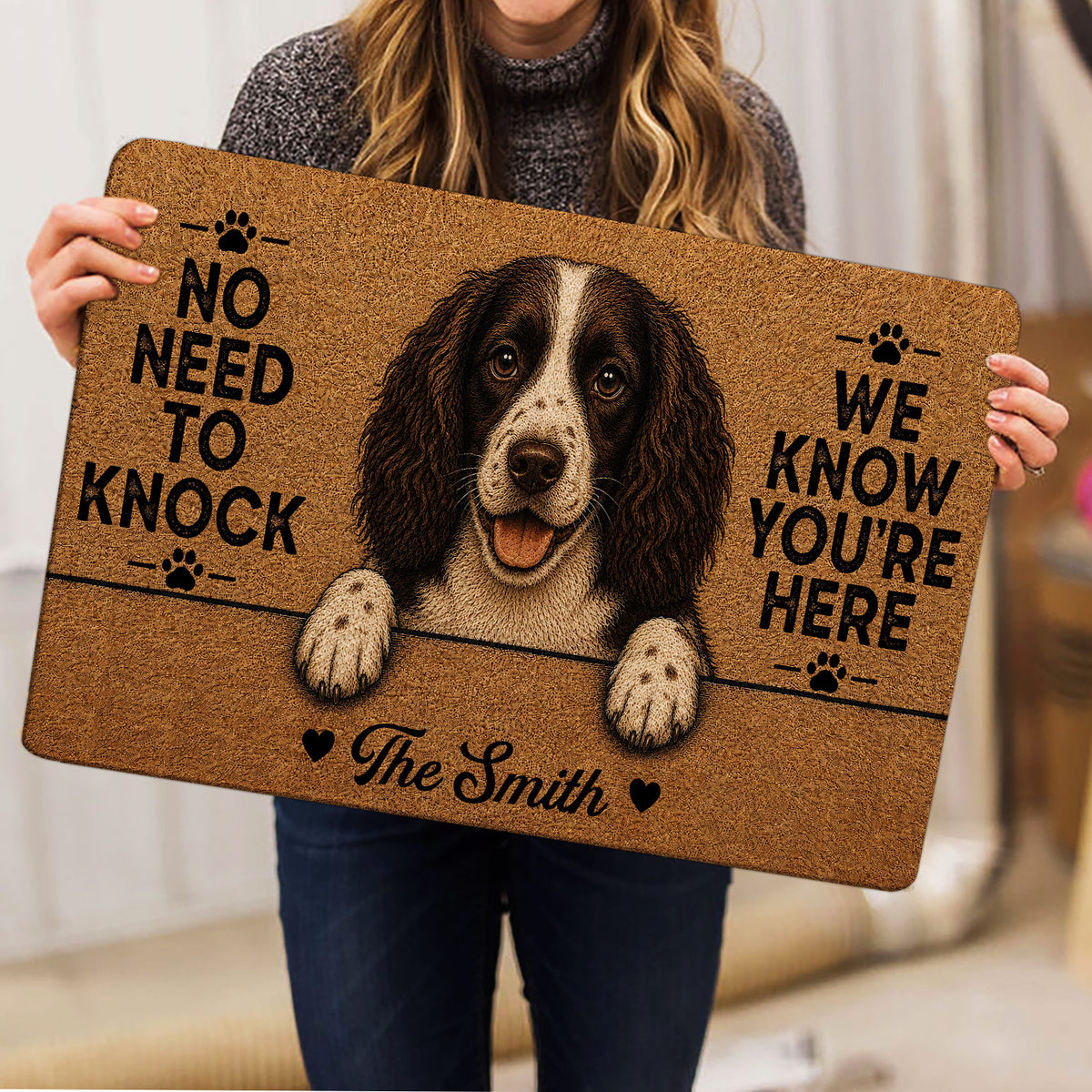 Person holding an English Springer Spaniel doormat featuring a detailed dog portrait and paw prints