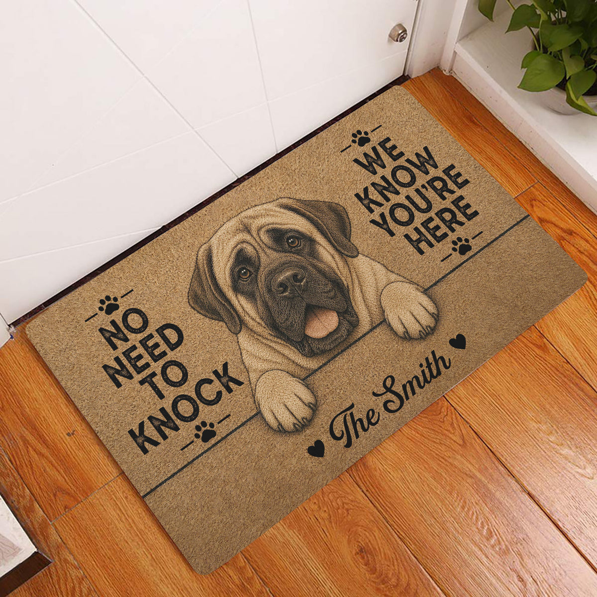 English Mastiff entryway rug displayed beside a white door on warm wood flooring