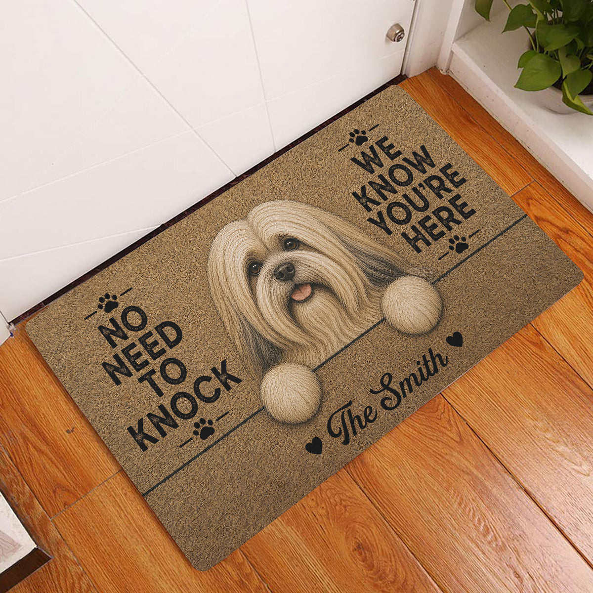 Lhasa Apso entryway rug displayed on a wood floor beside a door with a long-haired dog portrait