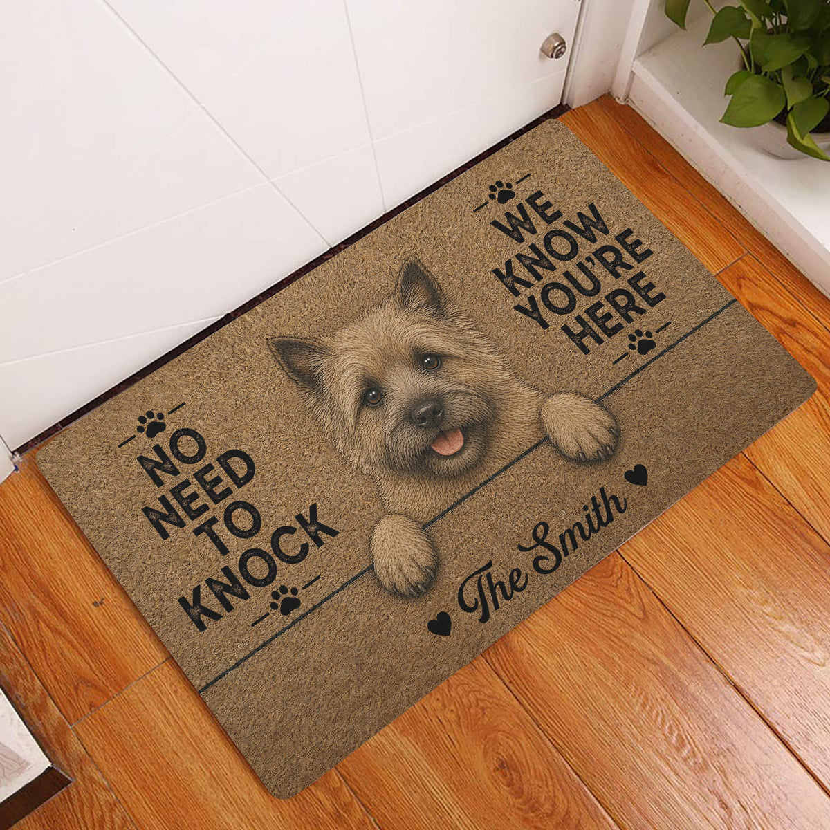Cairn Terrier entryway rug displayed beside a white door on hardwood flooring
