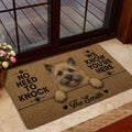 Cairn Terrier doormat shown in a home entryway near a glass door with warm rustic decor