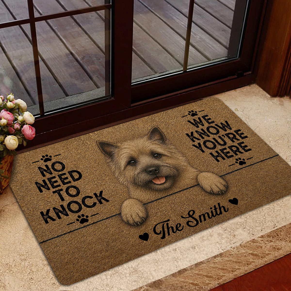 Cairn Terrier doormat shown in a home entryway near a glass door with warm rustic decor