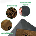 Close-up detail of the Pomeranian doormat surface, rubber backing, rounded edge, and printed paw motif