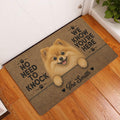Pomeranian entryway rug displayed beside a white door on hardwood flooring with a fluffy dog artwork