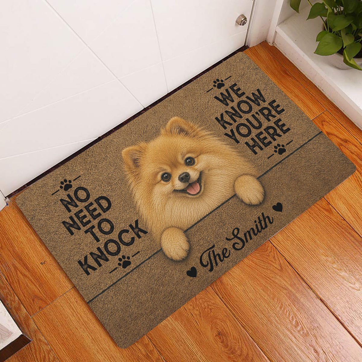 Pomeranian entryway rug displayed beside a white door on hardwood flooring with a fluffy dog artwork