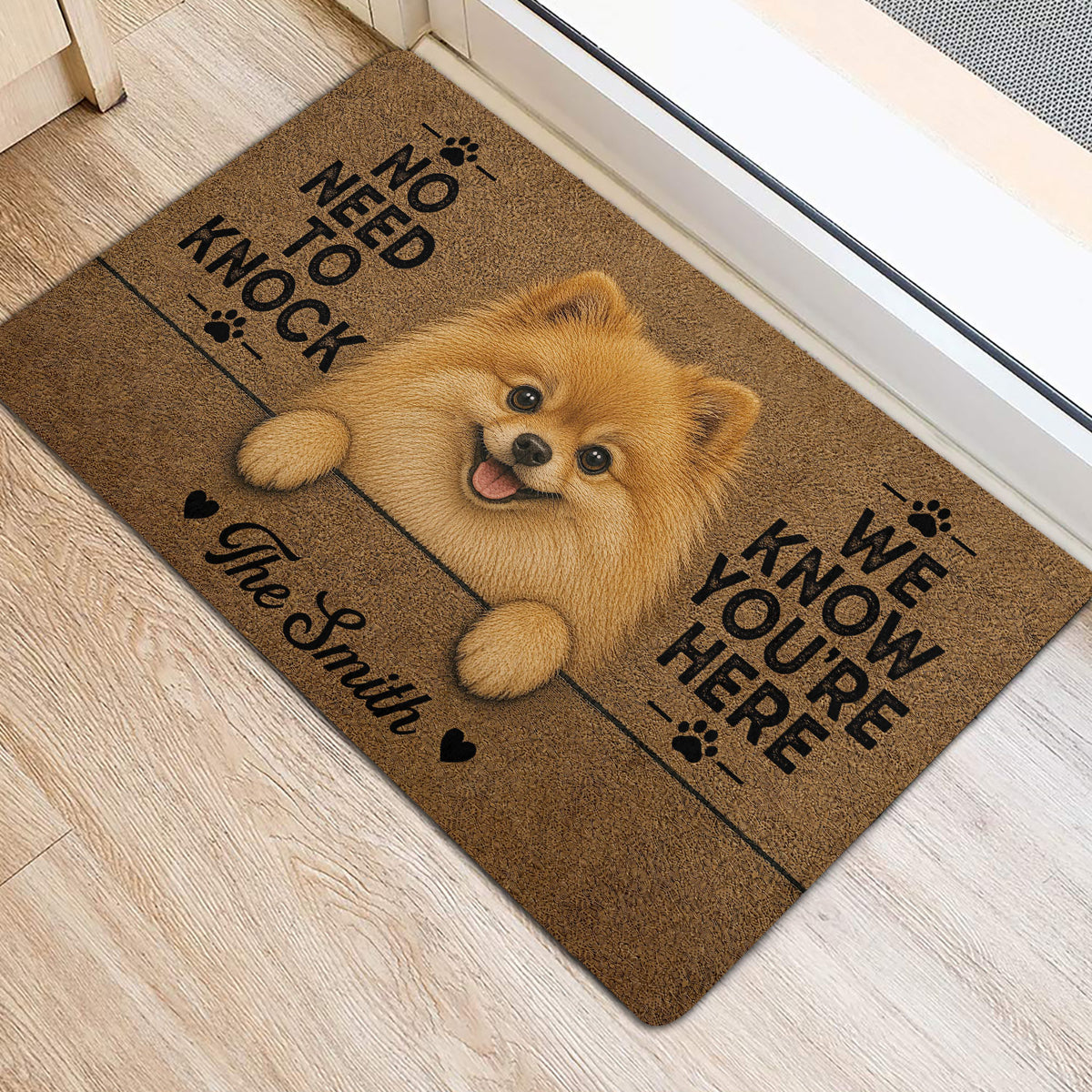 Pomeranian door mat shown at an indoor entrance with playful dog artwork, paw prints, and bold lettering