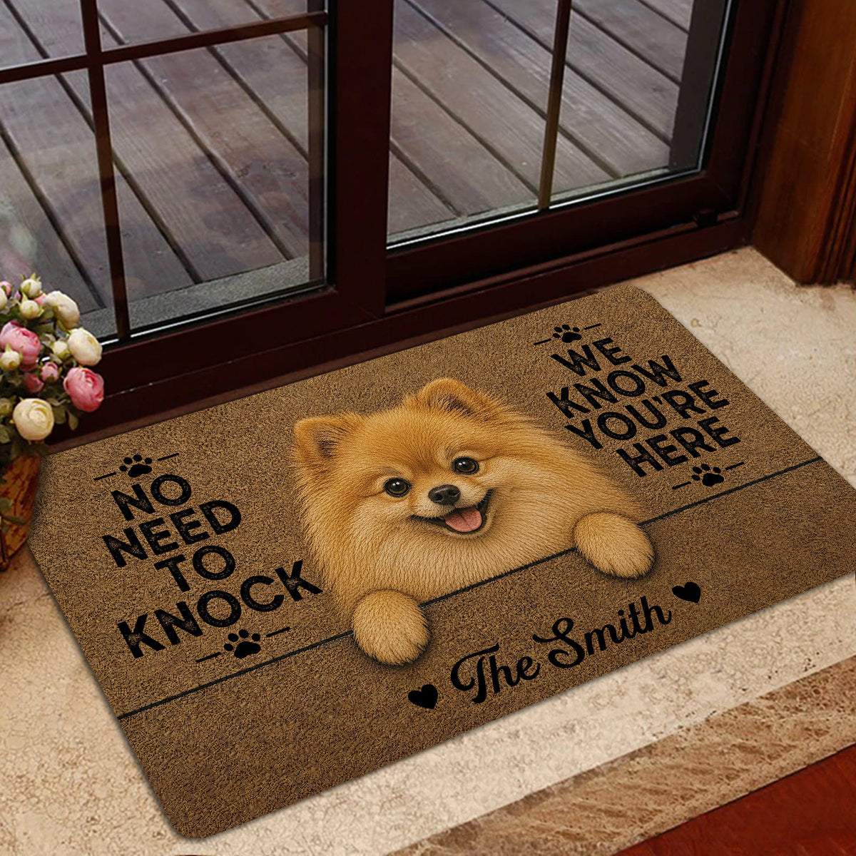 Pomeranian welcome mat styled near a glass door with a smiling fluffy dog illustration and brown textured artwork