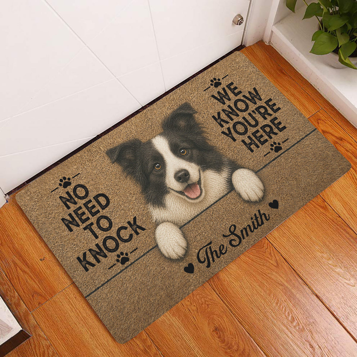 Border Collie entryway rug displayed beside a white door on a warm wood floor