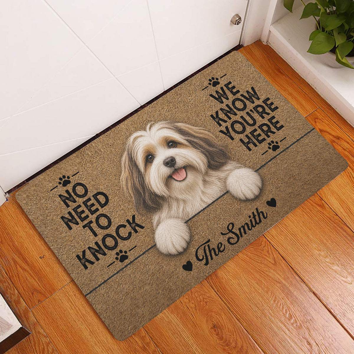Havanese dog doormat displayed in a bright wood-floor entryway with paw print artwork