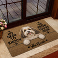 Havanese dog doormat styled at a home entrance with warm wood accents and floral decor