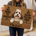 Person holding a Havanese dog doormat featuring a warm brown portrait and paw print details