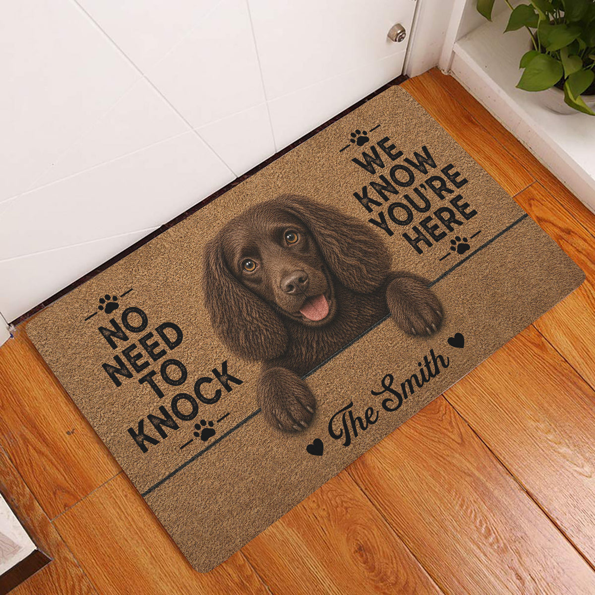 Brown Boykin Spaniel doormat styled at an indoor entryway on a warm wood floor