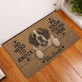 Saint Bernard entryway doormat displayed beside a white door on a warm wood floor