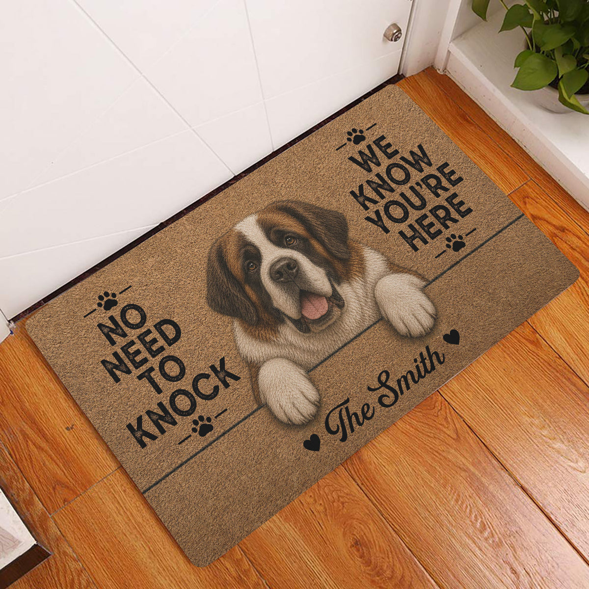 Saint Bernard entryway doormat displayed beside a white door on a warm wood floor