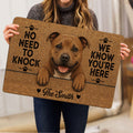 Staffordshire Bull Terrier door mat held indoors, featuring a cheerful dog portrait, paw prints and bold lettering
