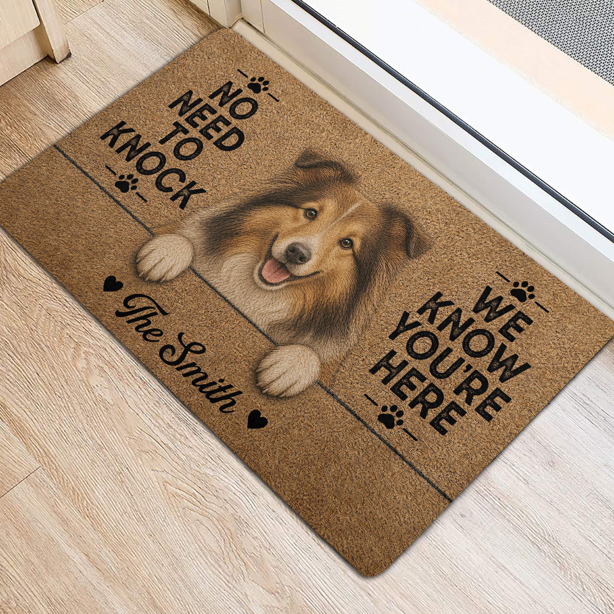 Sheltie entryway rug shown near a doorway with a central dog portrait, paw-print accents, and brown tones