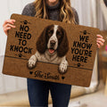 English Springer Spaniel doormat held indoors, featuring a detailed dog portrait and paw-print accents