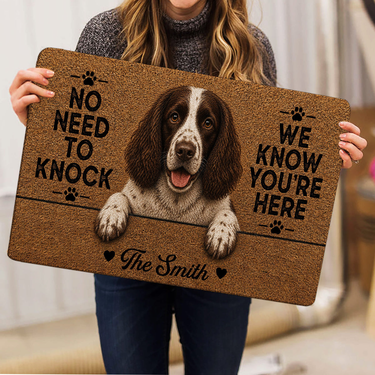 English Springer Spaniel doormat held indoors, featuring a detailed dog portrait and paw-print accents