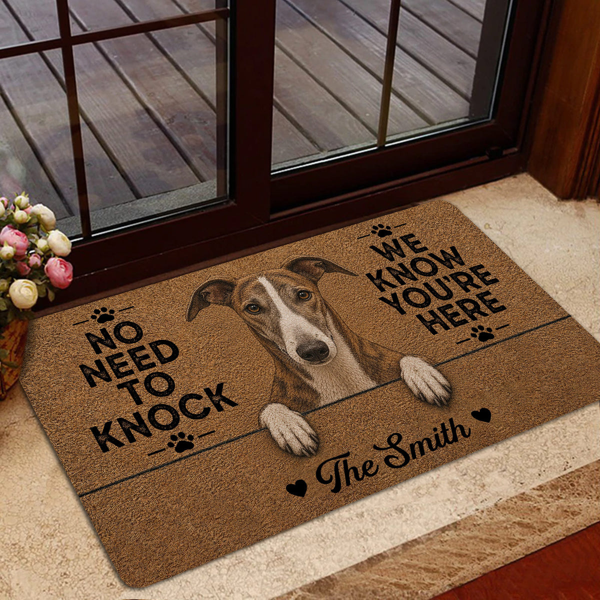 Greyhound welcome mat presented in a home entryway near glass doors and a floral arrangement