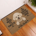 Bichon Frise entryway doormat displayed beside a white door on a warm wood floor