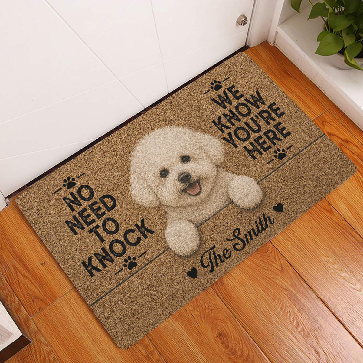 Bichon Frise entryway doormat displayed beside a white door on a warm wood floor