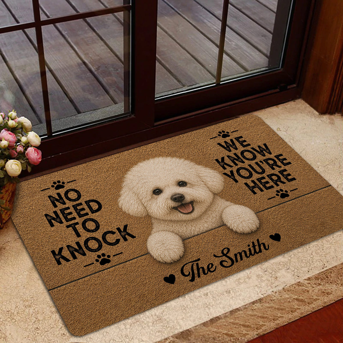 Bichon Frise welcome mat shown inside a glass entry door with a warm, cozy home setting