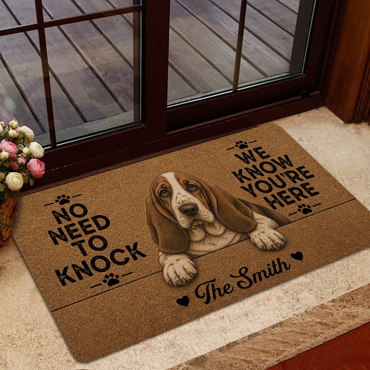Basset Hound welcome mat placed by a glass door in a warm home entryway