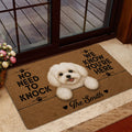 Maltese doormat styled in a home entrance with a white dog design, paw prints, and dark decorative lettering