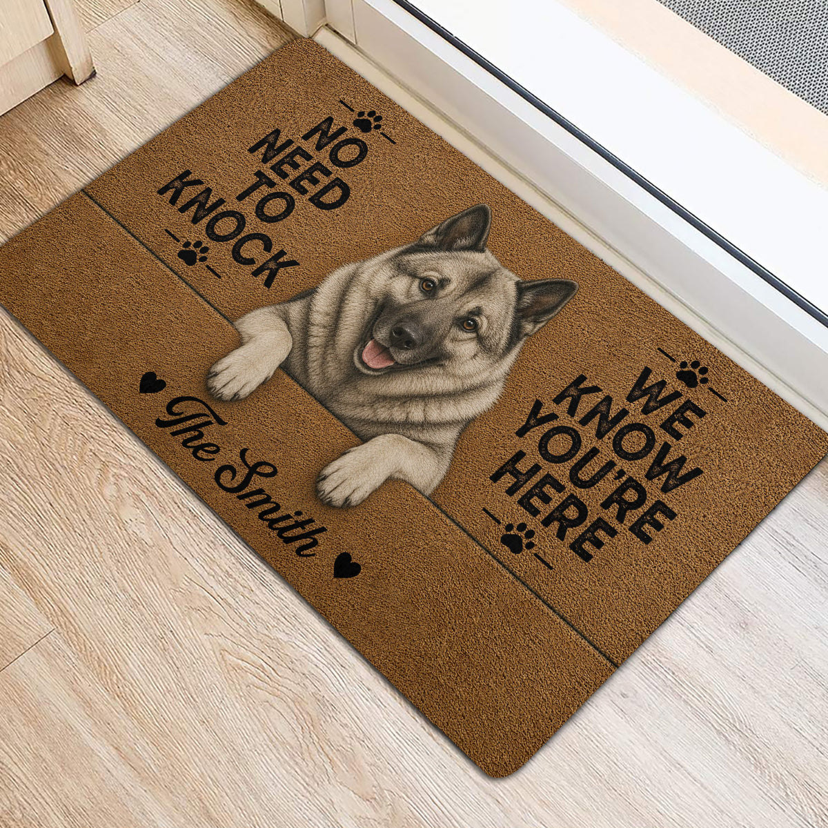 Gray Norwegian Elkhound rug positioned by a doorway with paw-print accents and bold black lettering