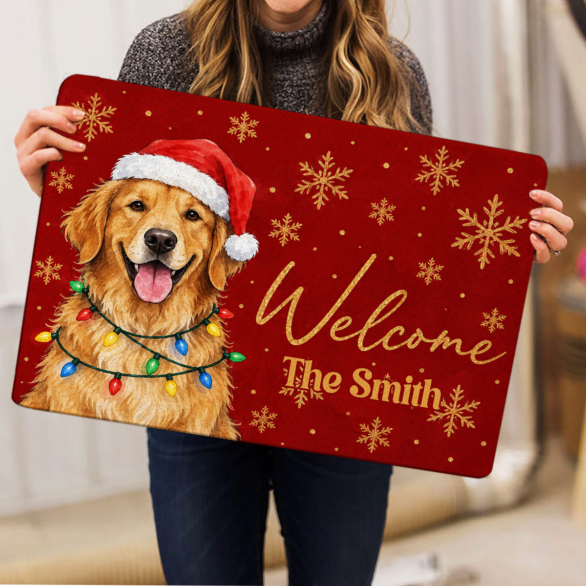 Person holding a red golden retriever Christmas doormat with snowflake artwork