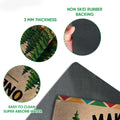 Close-up view of a camping doormat showing the printed felt surface and dark rubber backing