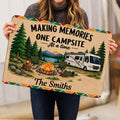 Camping rug held indoors, showing a colorful RV campsite scene with campfire, lake, trees, and chairs