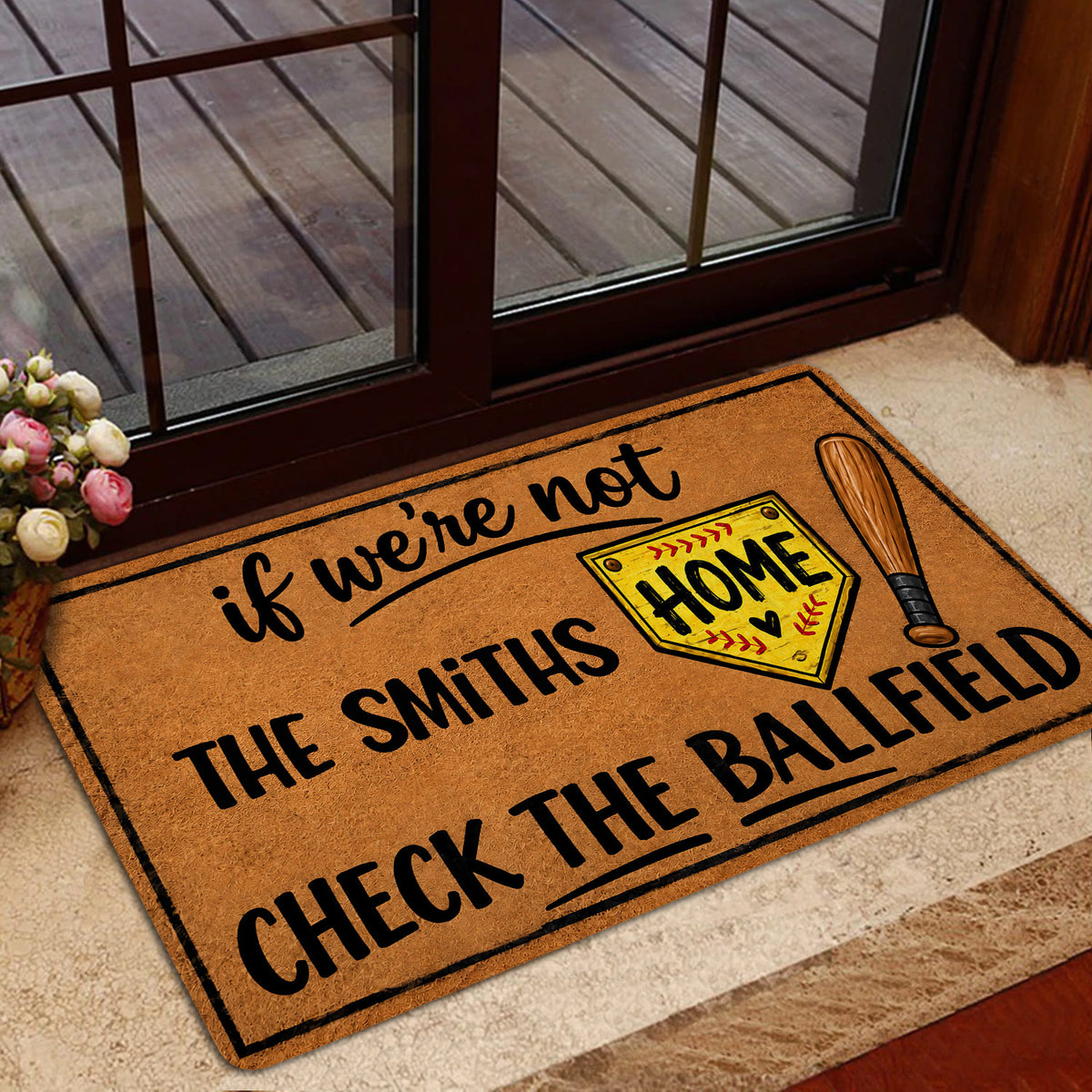 Softball doormat styled in a home entrance near a glass door with a playful ballfield design