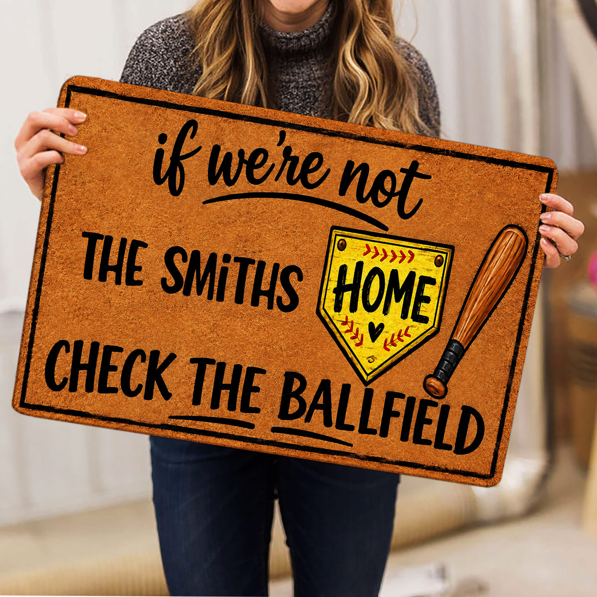 Softball doormat held indoors showing the bat, home plate, and bold ballfield artwork