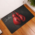 Boxing glove doormat styled in a home entryway on warm wood flooring
