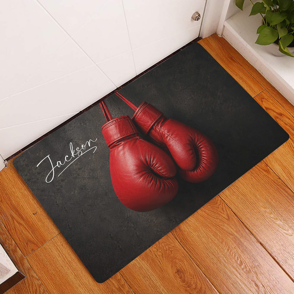 Boxing glove doormat styled in a home entryway on warm wood flooring