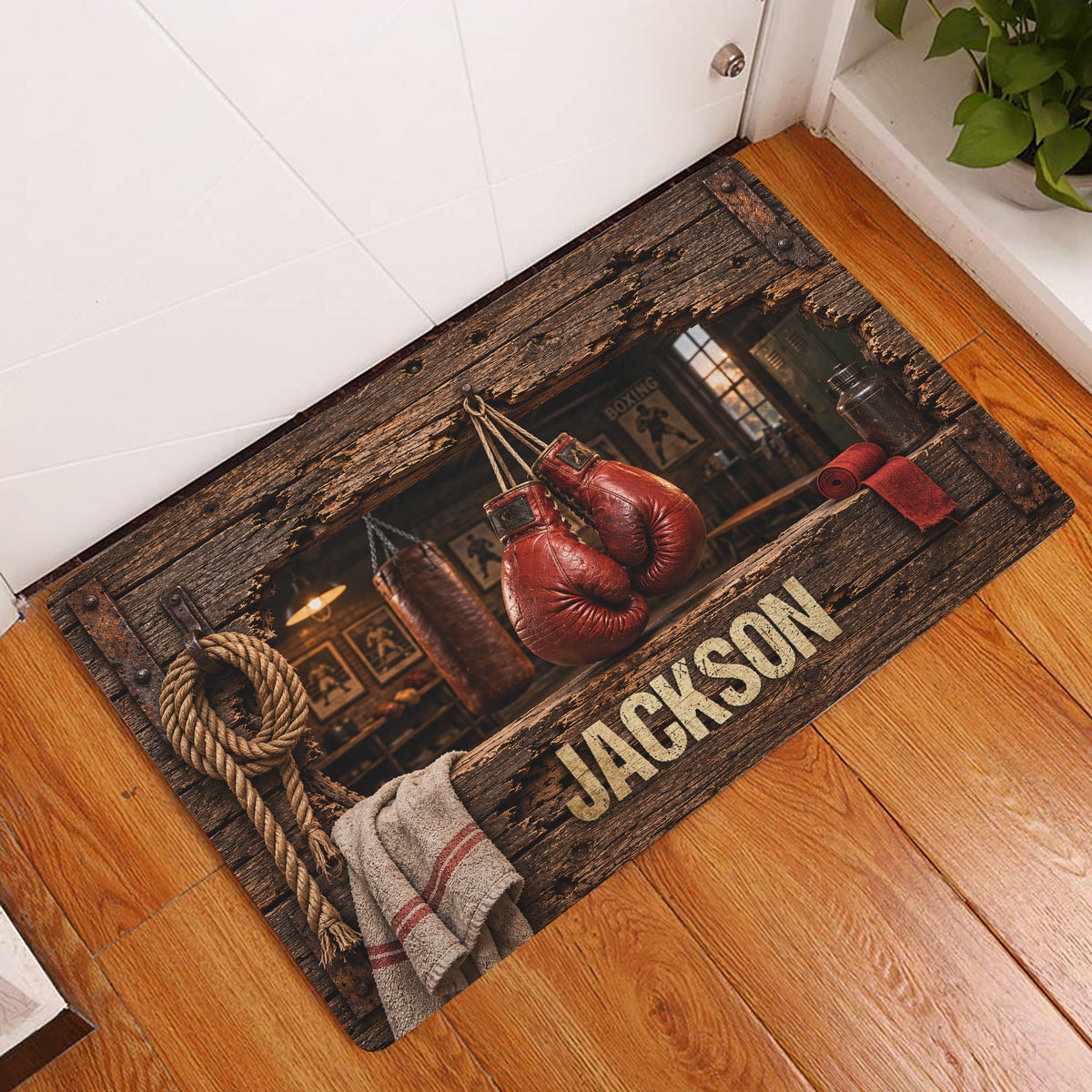 Boxing entryway rug displayed on a wood floor near a door, featuring red gloves and rustic gym artwork