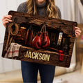 Boxing rug held indoors, displaying red gloves, punching bag, rope, and vintage gym artwork