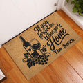 Wine bottle and glass doormat displayed in a home entryway on a wood floor