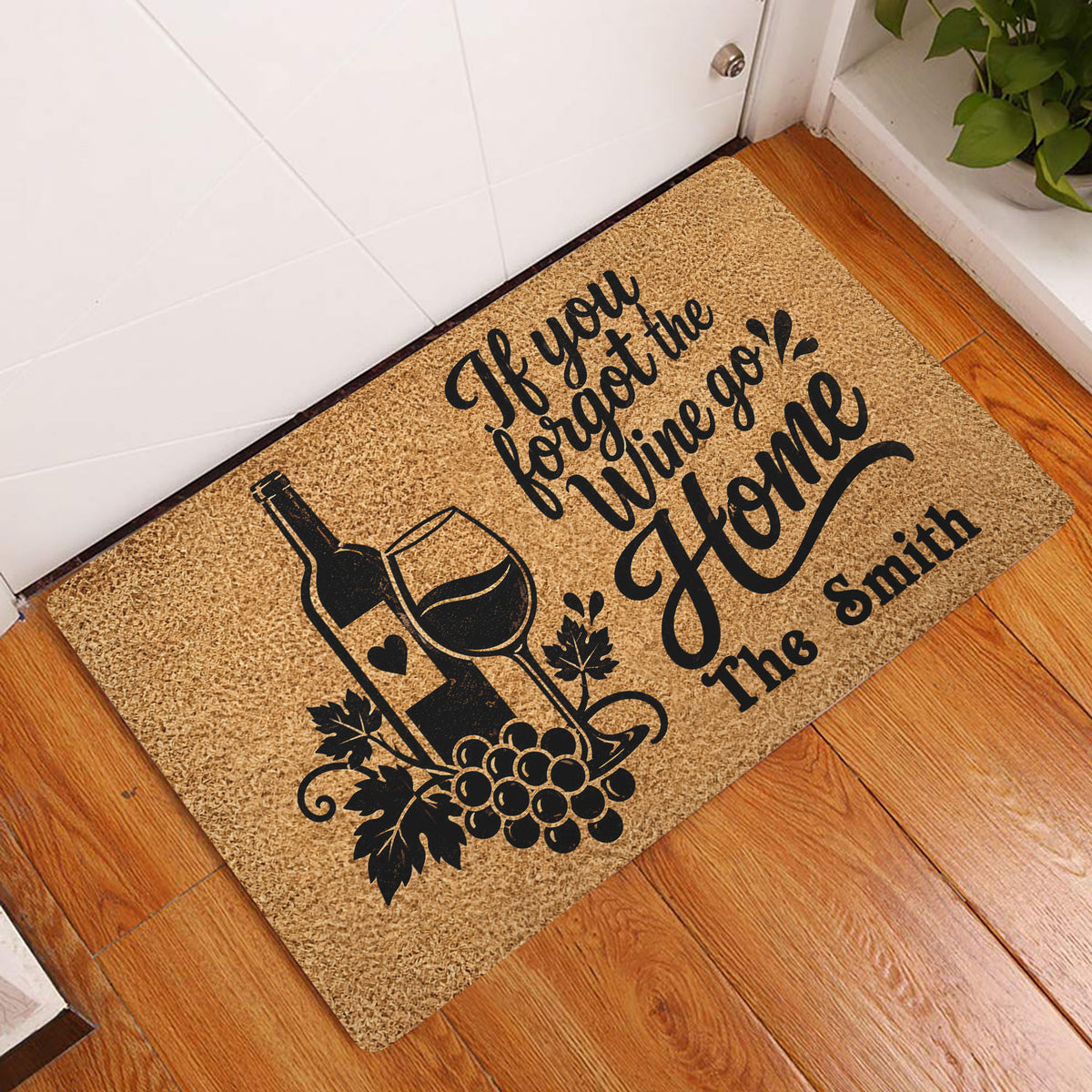 Wine bottle and glass doormat displayed in a home entryway on a wood floor