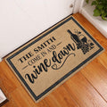 Wine-themed entryway doormat displayed beside a white door on wood flooring