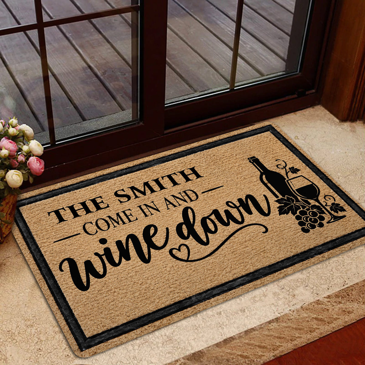 Wine-themed front door mat displayed in a warm home entrance with glass doors