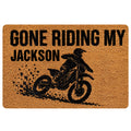 Motocross doormat with a bold black dirt bike rider graphic and muddy splash artwork