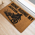 Motocross rider and dirt bike doormat styled at an indoor doorway on a light floor