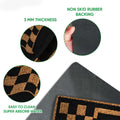 Close-up motocross doormat detail showing the printed checkered flag design, surface texture and backing