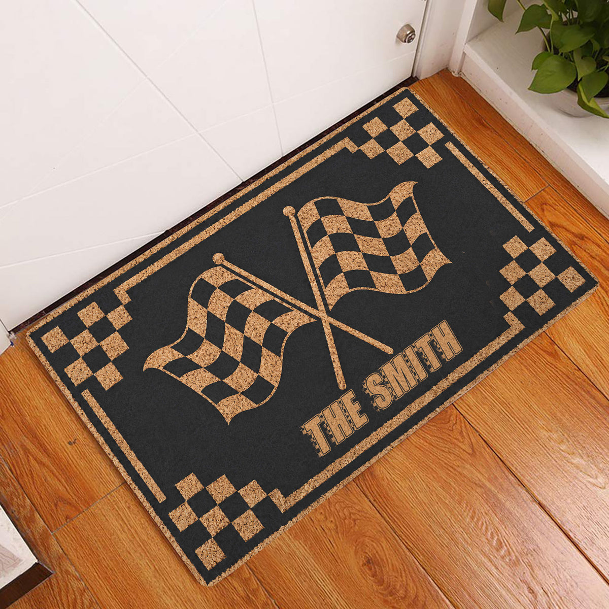 Checkered flag motocross doormat styled at a home entryway beside a white door and wood floor