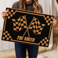 Motocross doormat with crossed racing flags and black and gold border shown in a lifestyle presentation
