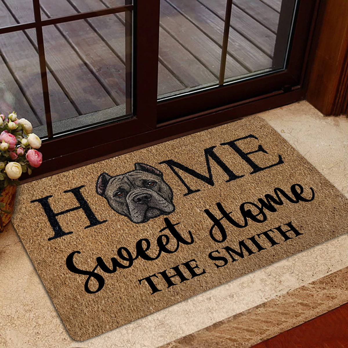 Cane Corso doormat styled at a glass doorway with warm brown tones and welcoming typography